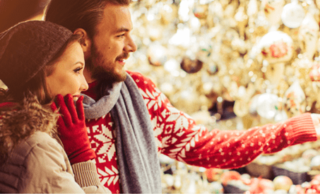 Couple looking at ornaments together.