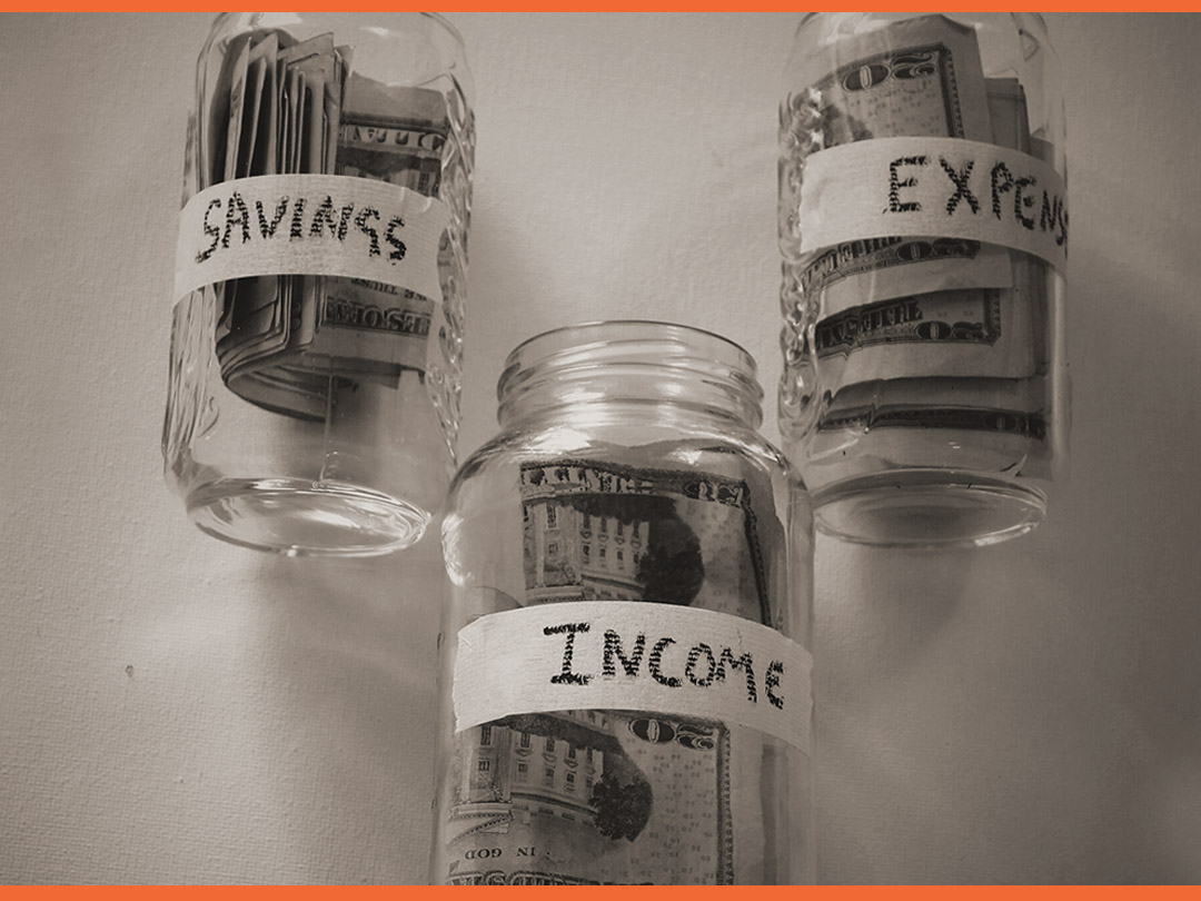 Small bottles with money in each labeled "SAVINGS, EXPENSES, INCOME."