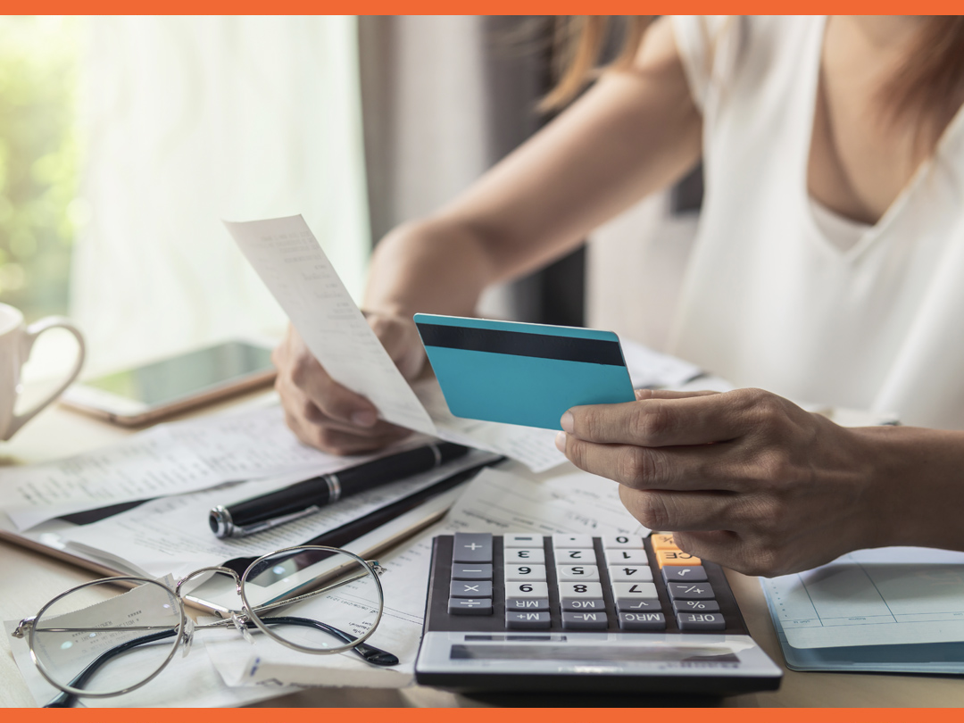 Woman reviewing her bills and credit card.