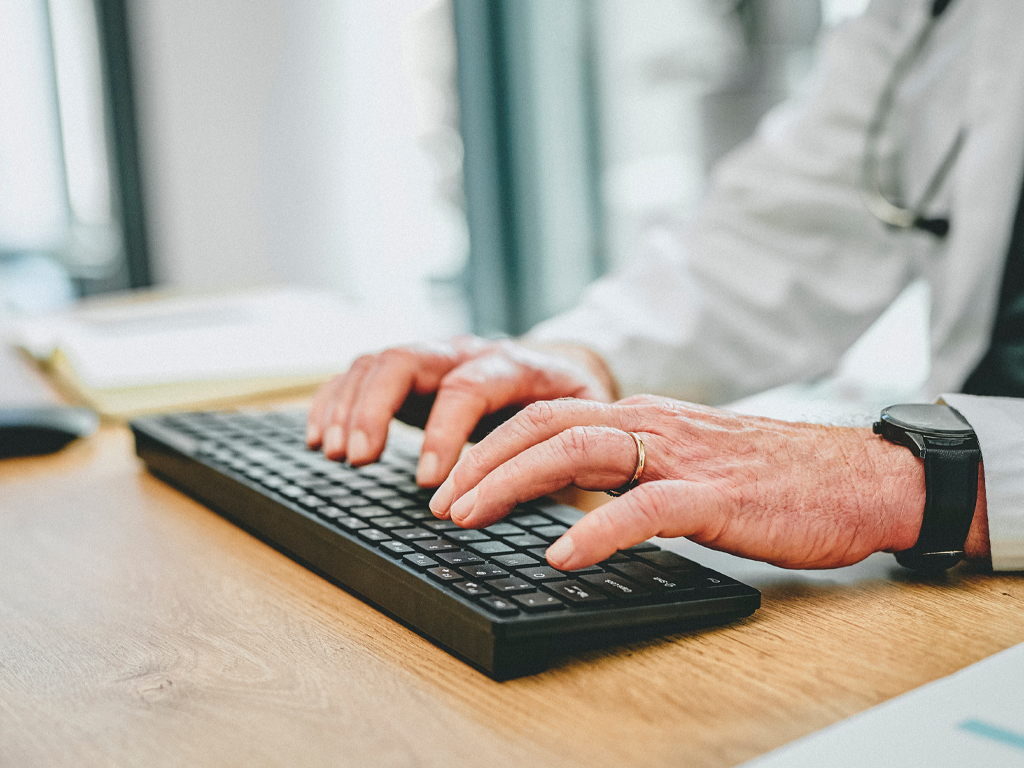 An older man using a keyboard.